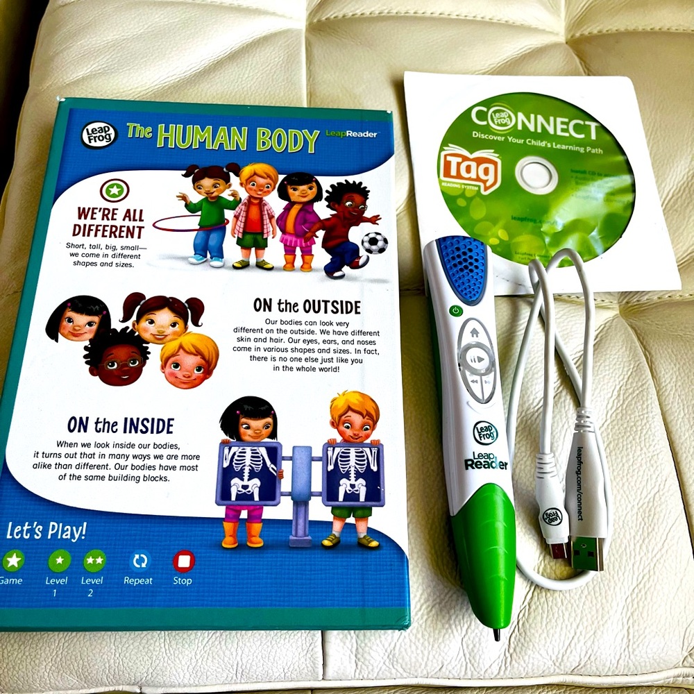 Leap Frog Reader Pen with charger, CD, and a book.